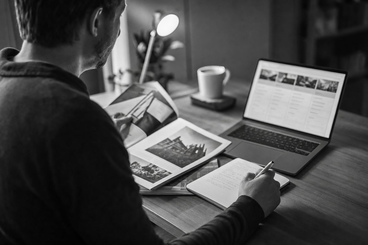 Adult learner reviewing course options on a laptop and taking notes